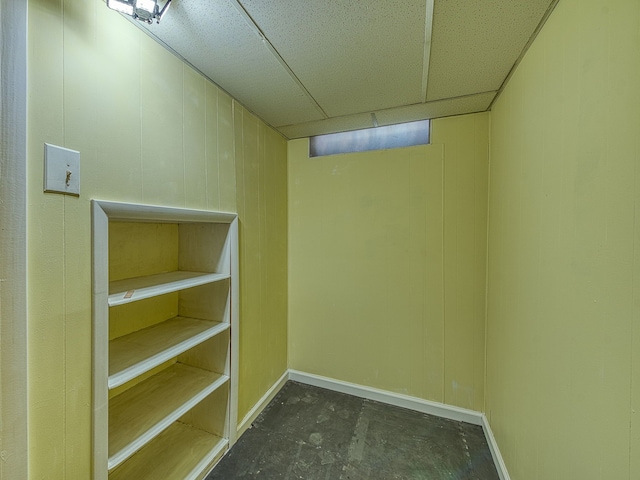 finished basement featuring a paneled ceiling