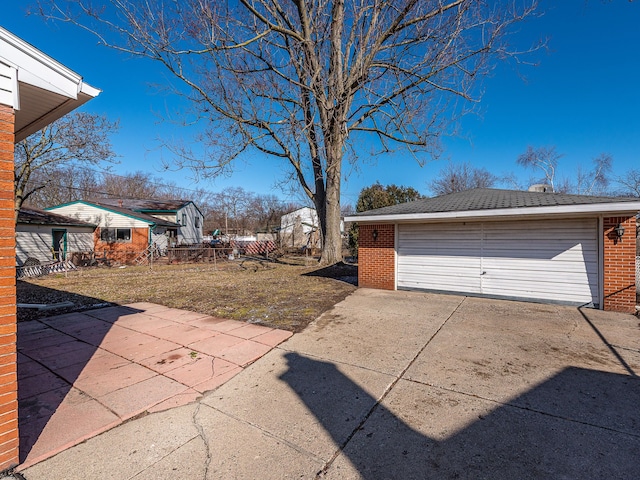 exterior space featuring a detached garage and an outdoor structure