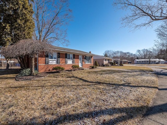 single story home with a front lawn and brick siding