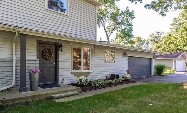 view of front of property featuring aphalt driveway, an attached garage, and brick siding