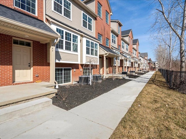 view of home's community featuring fence and a residential view