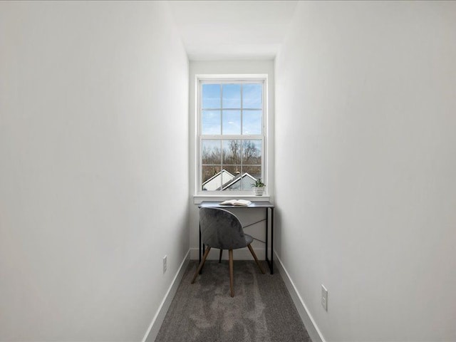 office area featuring dark colored carpet and baseboards