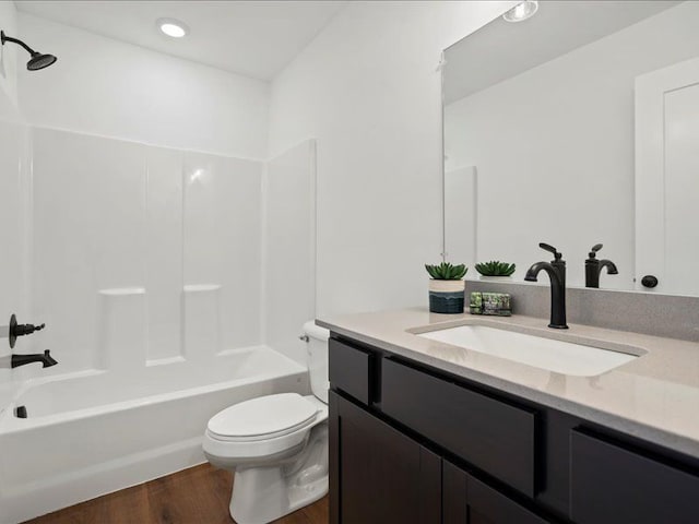 bathroom featuring vanity,  shower combination, toilet, and wood finished floors