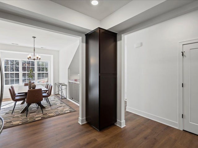 545 Village Ln, Milford, MI 48381 - dining area featuring dark wood-style floors, a notable chandelier, and baseboards