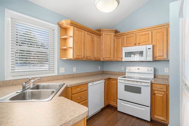 kitchen featuring white appliances, vaulted ceiling, light countertops, and a sink