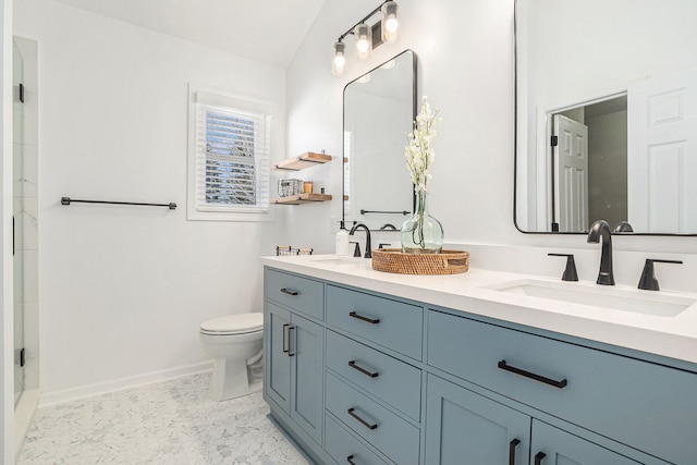 full bath featuring a sink, baseboards, toilet, and double vanity