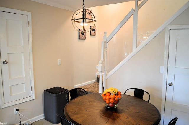 dining area featuring stairs, crown molding, and baseboards