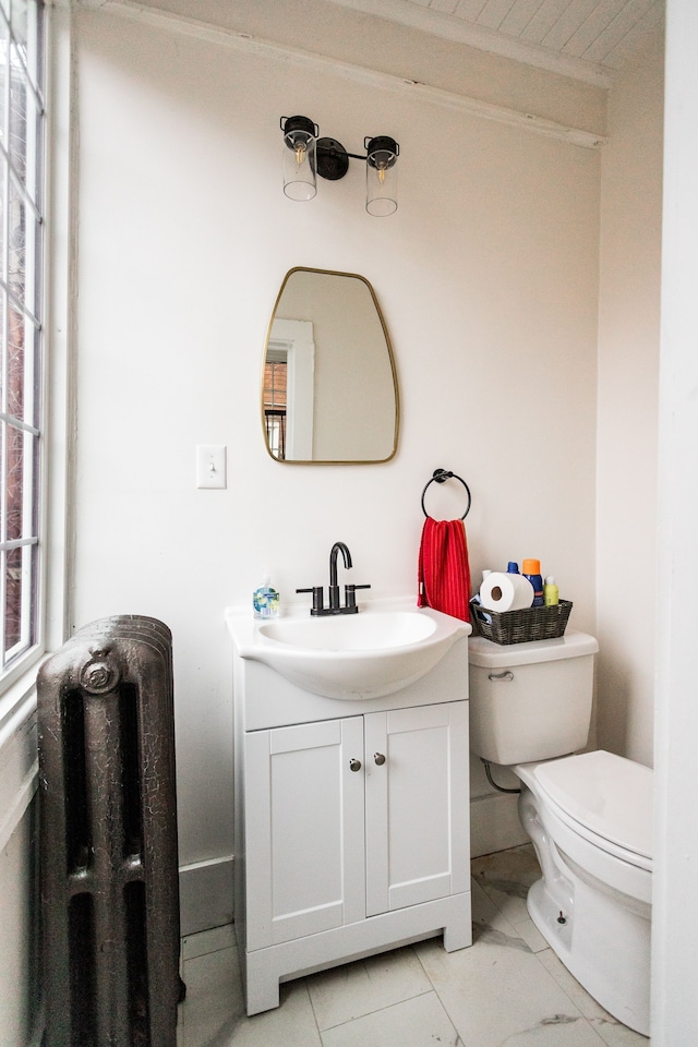 bathroom featuring vanity, toilet, marble finish floor, and ornamental molding