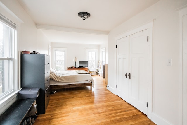 bedroom with light wood-style flooring and a closet