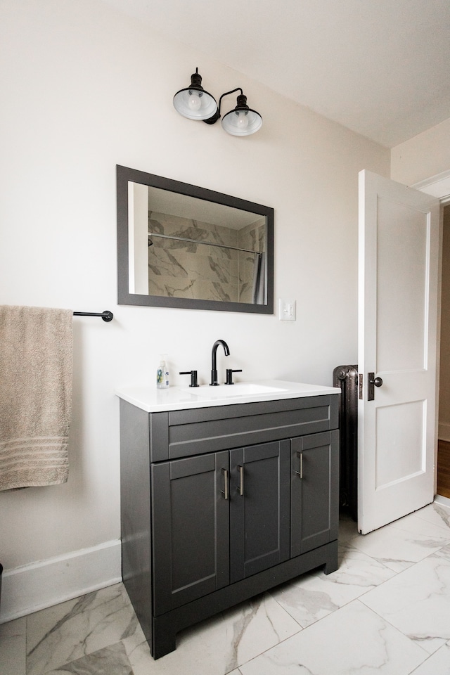 full bathroom featuring marble finish floor, vanity, and baseboards