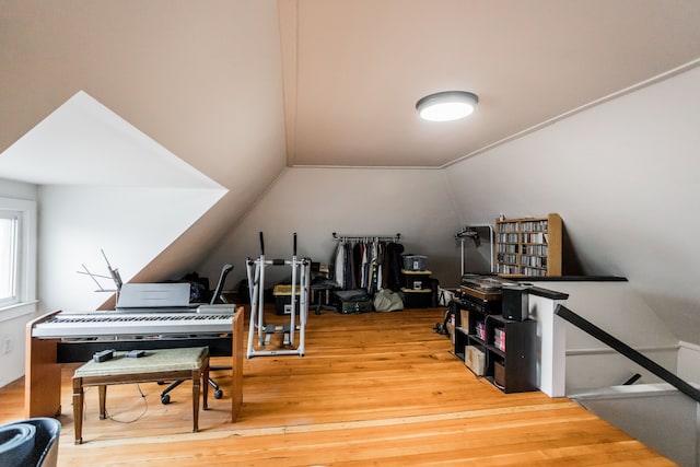 interior space featuring hardwood / wood-style floors and vaulted ceiling