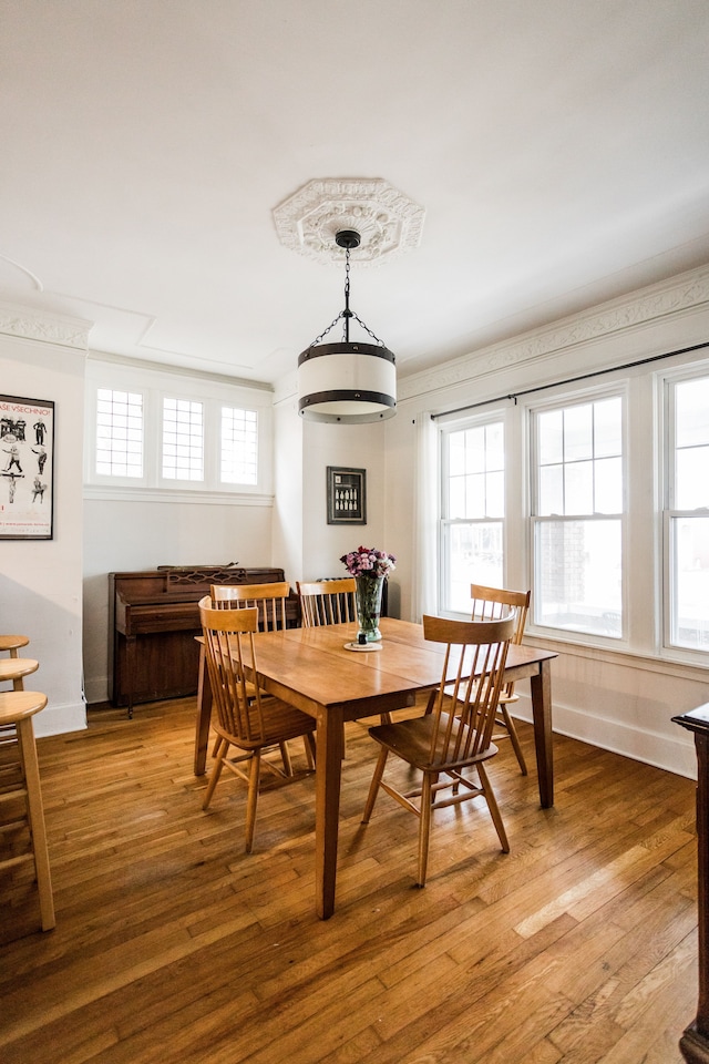 dining area with a healthy amount of sunlight, light wood-type flooring, and baseboards