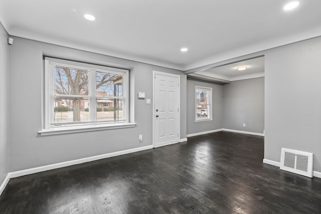 entryway featuring a wealth of natural light, visible vents, and wood finished floors