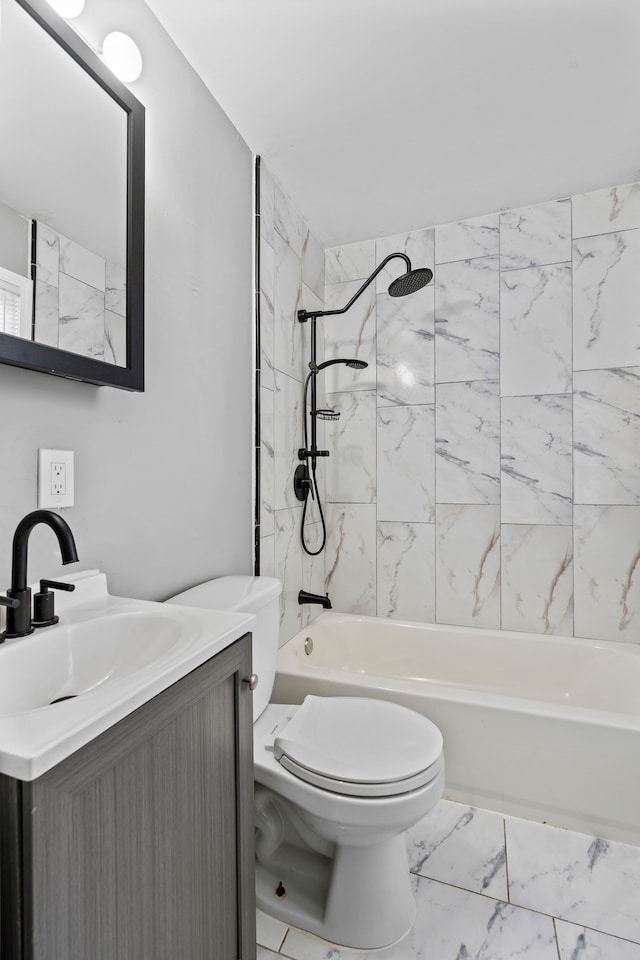 full bathroom featuring washtub / shower combination, toilet, marble finish floor, and vanity