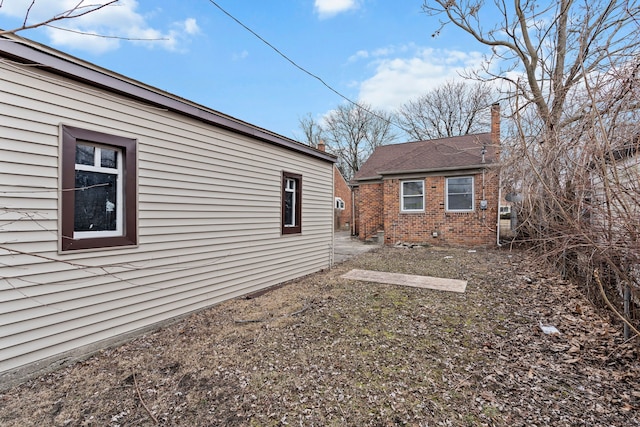 view of side of property featuring brick siding