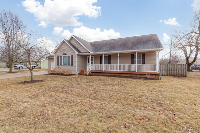 ranch-style home with covered porch, a front lawn, and fence