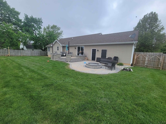 back of property with a fire pit, a fenced backyard, a lawn, and a patio area