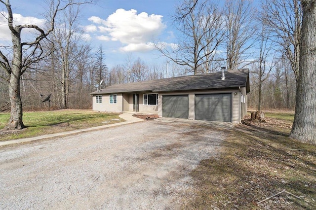 view of front of property with a garage, a front lawn, and driveway