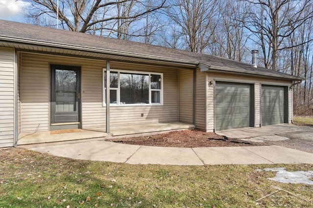 entrance to property with an attached garage, covered porch, and roof with shingles