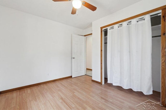 unfurnished bedroom featuring a closet, a ceiling fan, light wood-type flooring, and baseboards