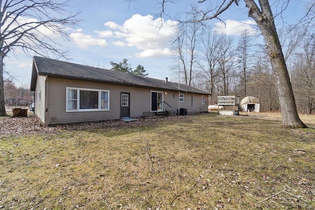 back of property featuring a lawn