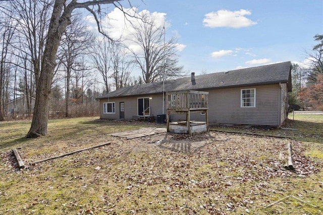 rear view of property featuring a wooden deck