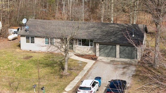 view of front of home with a garage, a front lawn, driveway, and a shingled roof