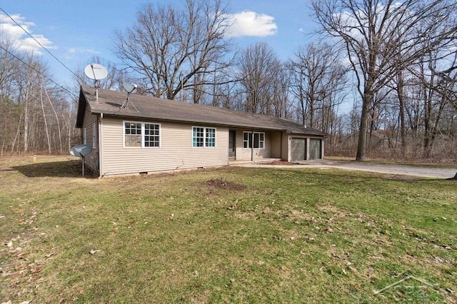 ranch-style house with a front yard, an attached garage, driveway, and crawl space