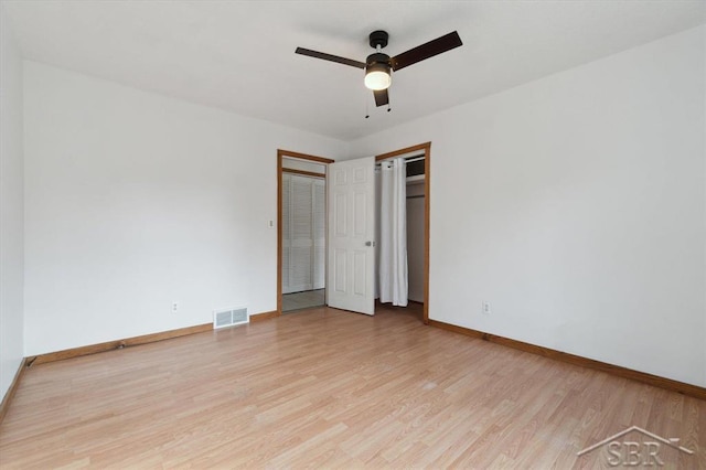 unfurnished bedroom with visible vents, ceiling fan, light wood-type flooring, and baseboards