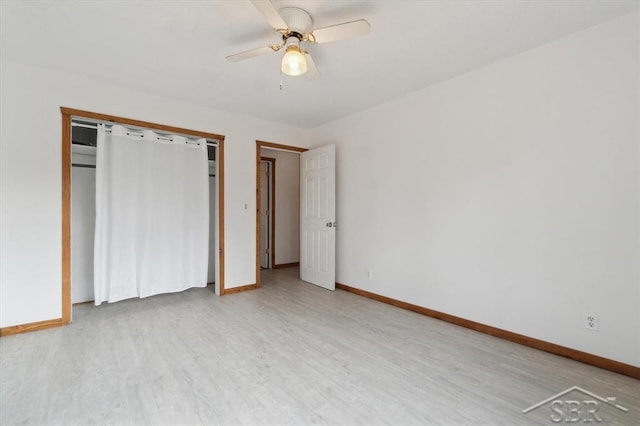 unfurnished bedroom featuring baseboards, wood finished floors, and a ceiling fan