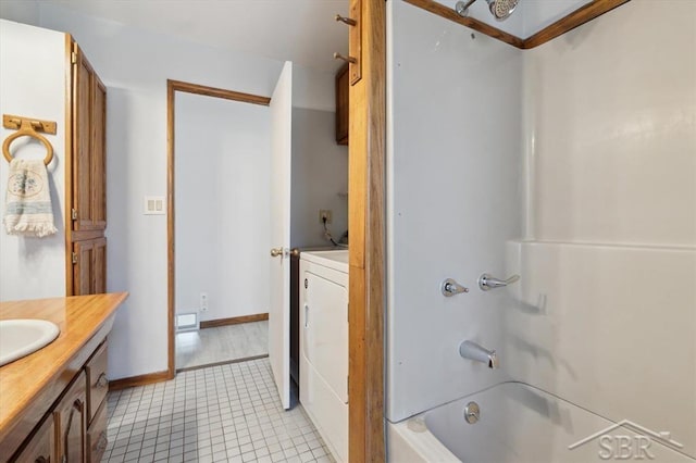 full bathroom featuring baseboards, shower / tub combination, washer / dryer, tile patterned floors, and vanity