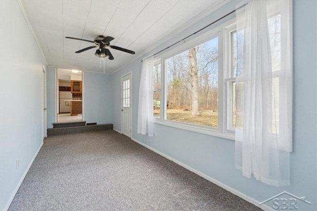 unfurnished room with carpet flooring, crown molding, and baseboards