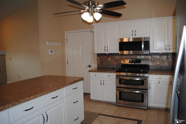 kitchen with light tile patterned floors, a ceiling fan, appliances with stainless steel finishes, white cabinetry, and backsplash