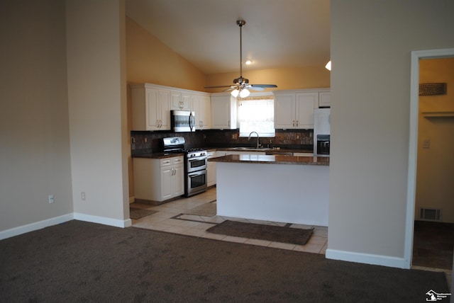 kitchen featuring a sink, light colored carpet, white cabinetry, and stainless steel appliances