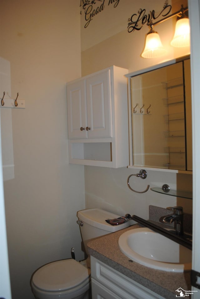 bathroom featuring toilet and vanity