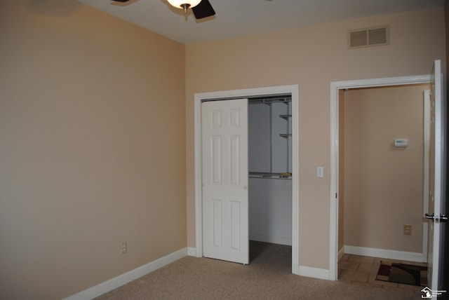 unfurnished bedroom featuring visible vents, baseboards, and carpet floors