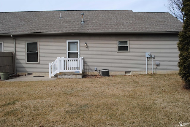 rear view of house with a shingled roof, central air condition unit, a lawn, and crawl space