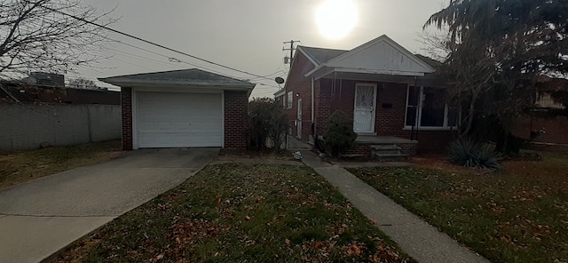 bungalow-style house featuring an outdoor structure, concrete driveway, and brick siding