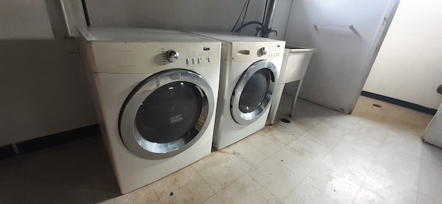 laundry area featuring washing machine and clothes dryer and laundry area