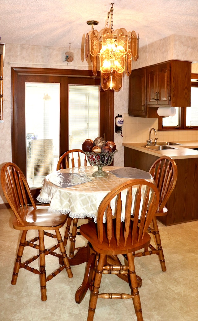 dining space with plenty of natural light and an inviting chandelier