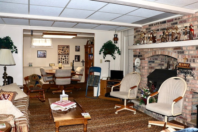 living area with a drop ceiling and carpet floors