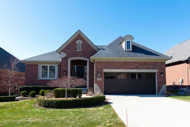 view of front of property featuring an attached garage, brick siding, driveway, and roof with shingles