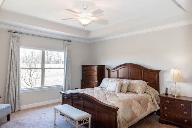 bedroom featuring light carpet, baseboards, a tray ceiling, and ornamental molding