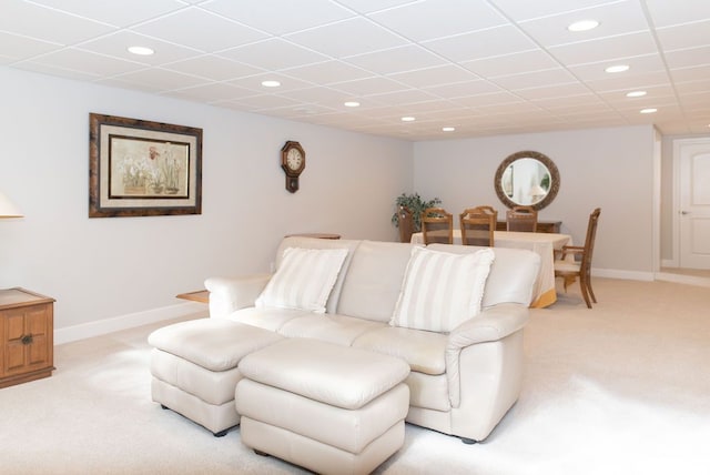 living area featuring recessed lighting, light colored carpet, a paneled ceiling, and baseboards