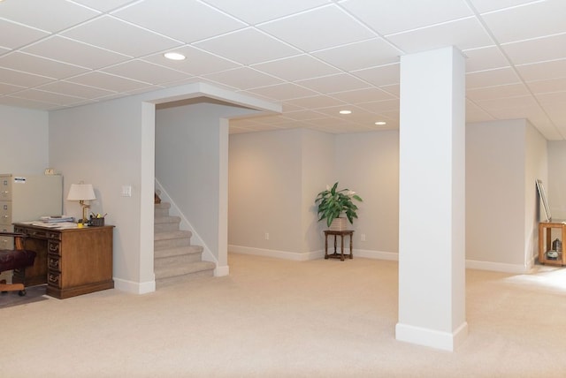 finished basement with a drop ceiling, recessed lighting, stairway, carpet floors, and baseboards