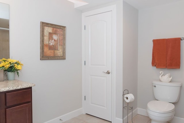 bathroom with tile patterned flooring, toilet, vanity, and baseboards