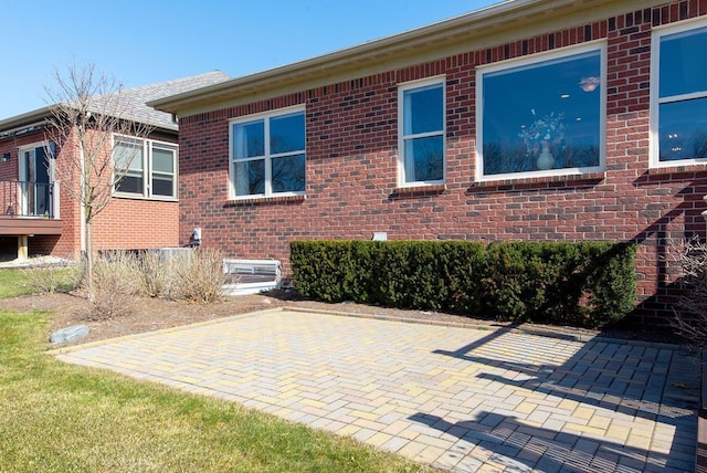 view of property exterior featuring brick siding