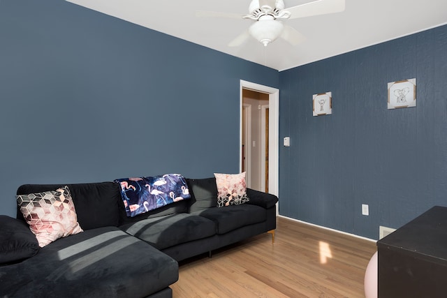 living area with ceiling fan and wood finished floors