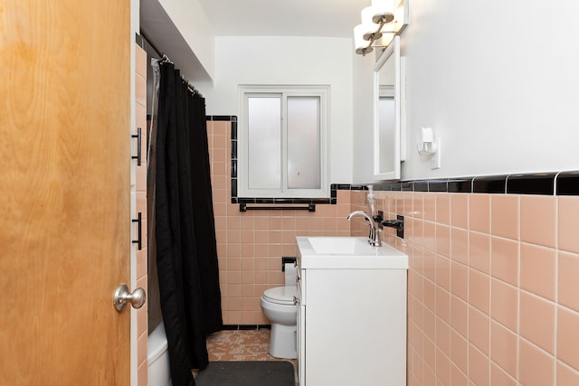 full bath featuring toilet, shower / tub combo with curtain, tile walls, tile patterned flooring, and vanity