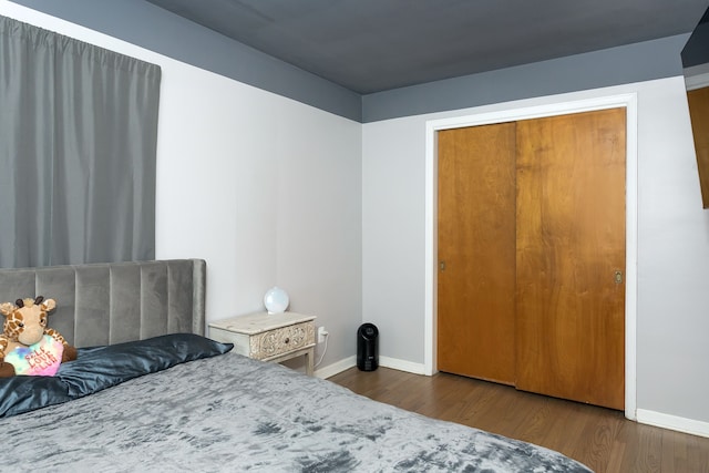 bedroom featuring baseboards and wood finished floors